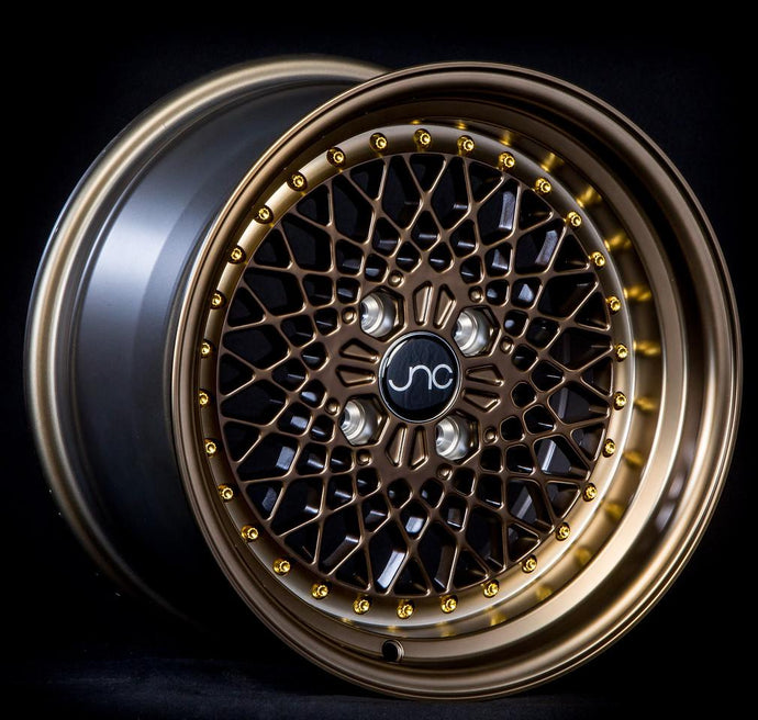 JNC045 | Machined Bronze w/ Gold Rivets | 15x8.25 | 4x100 | +10mm | CB: 73.1